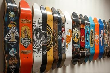 Various skateboard decks hanging on a wall